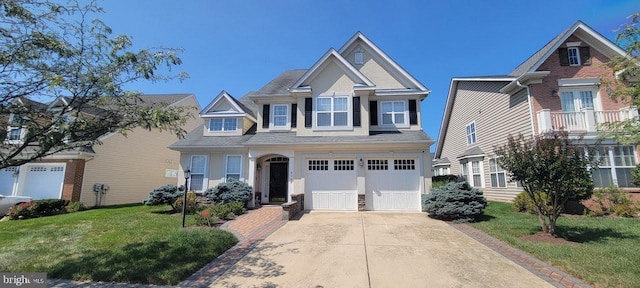 view of front of property featuring a front yard and a garage