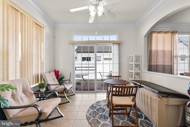 interior space with light tile patterned floors, crown molding, and ceiling fan