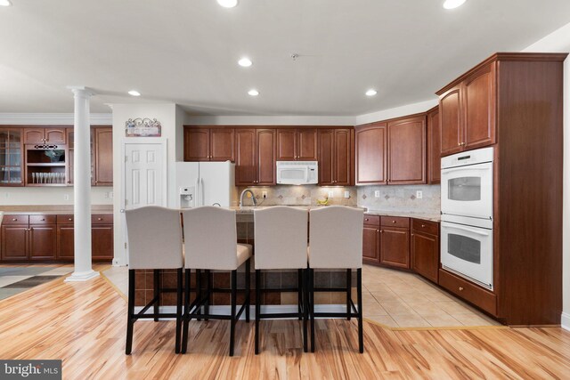 dining area featuring light wood-type flooring and crown molding