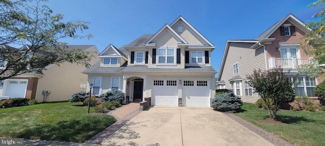 view of front of property with a garage and a front lawn