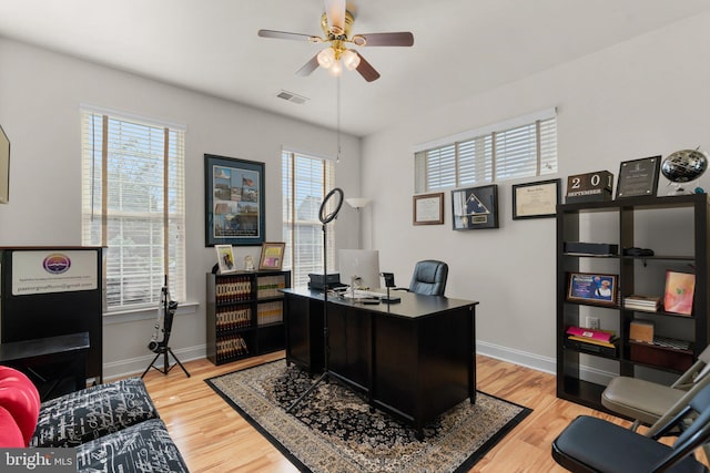 home office featuring ceiling fan and light hardwood / wood-style flooring