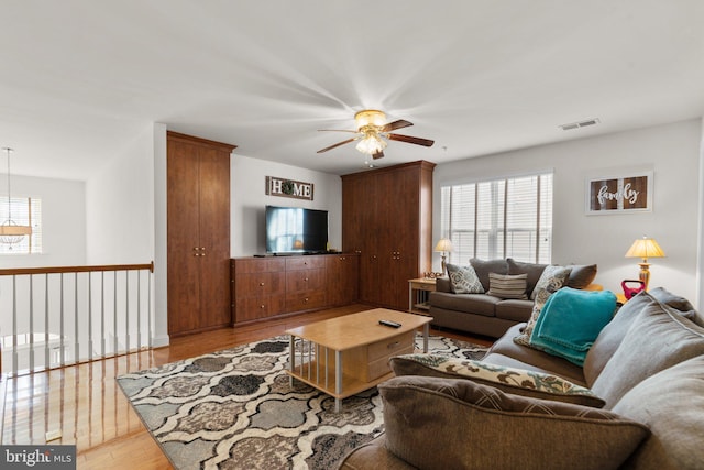 living room featuring ceiling fan and light hardwood / wood-style flooring