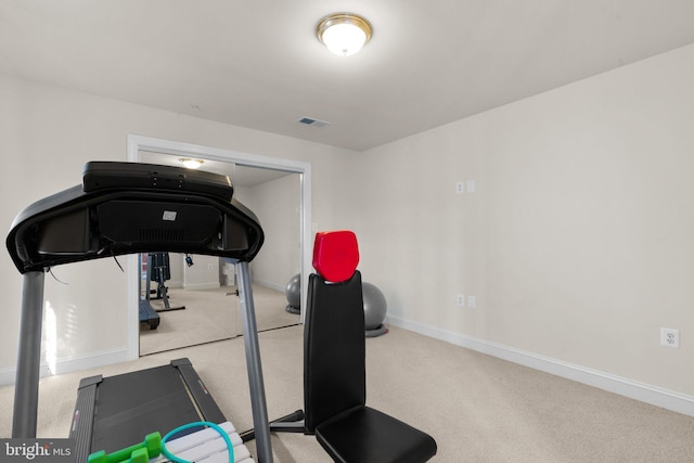 exercise area featuring light colored carpet