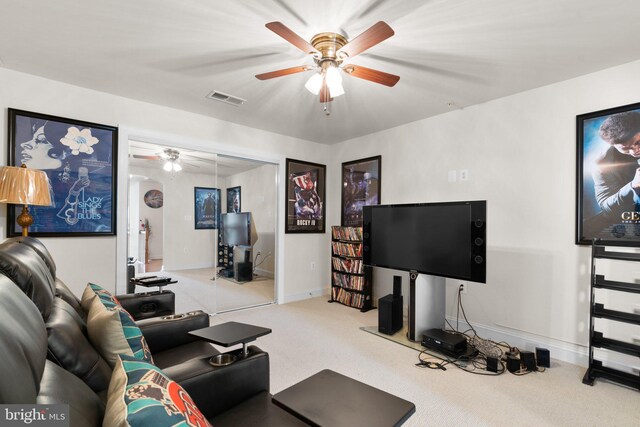 carpeted living room with ceiling fan