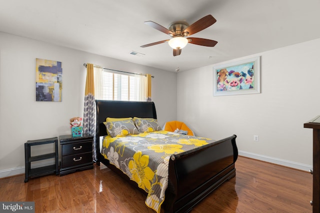 bedroom with ceiling fan and dark hardwood / wood-style flooring