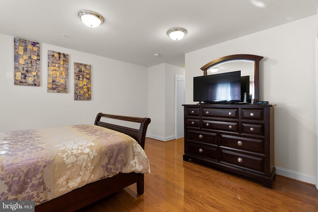 bedroom with hardwood / wood-style floors