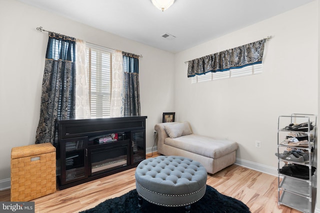 living area with hardwood / wood-style flooring