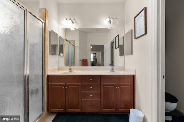 bathroom featuring vanity, tile patterned flooring, an enclosed shower, and toilet