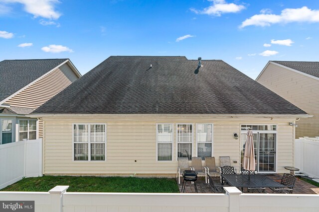 back of house with a lawn and a patio area