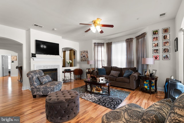 living room featuring wood-type flooring and ceiling fan