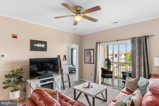 living room with ceiling fan, light colored carpet, and ornamental molding