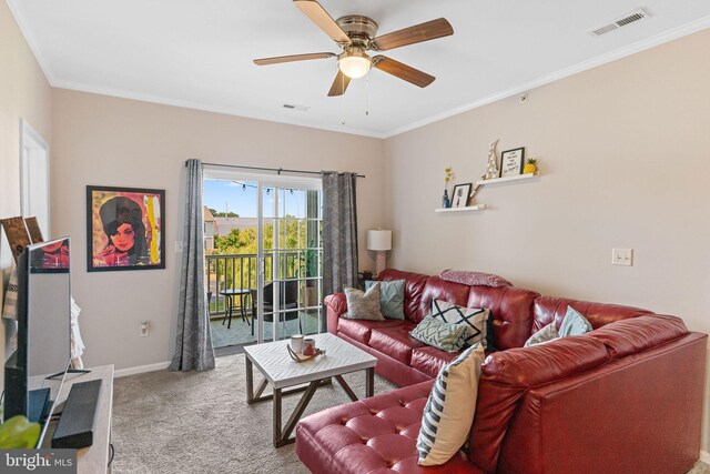 living room featuring ceiling fan, ornamental molding, and carpet floors