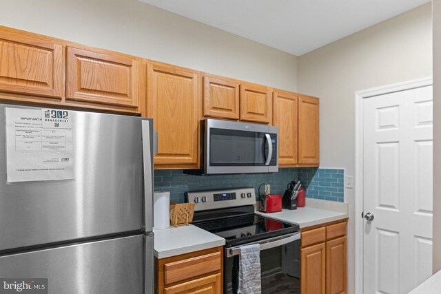 kitchen featuring tasteful backsplash and stainless steel appliances