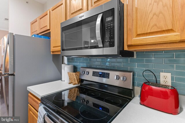 kitchen featuring backsplash and stainless steel appliances