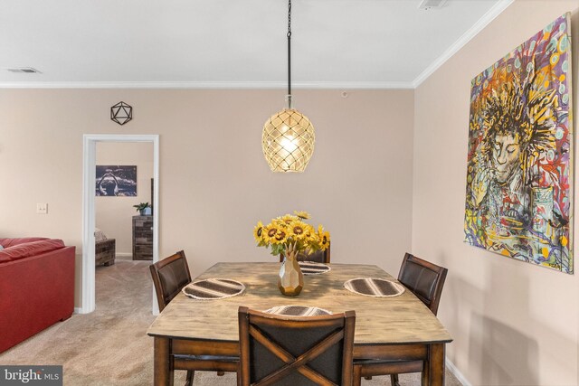 dining room featuring light colored carpet and ornamental molding