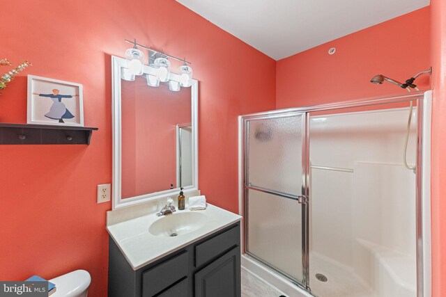 bathroom with vanity, toilet, and walk in shower