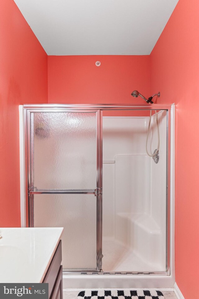 bathroom with vanity and a shower with shower door