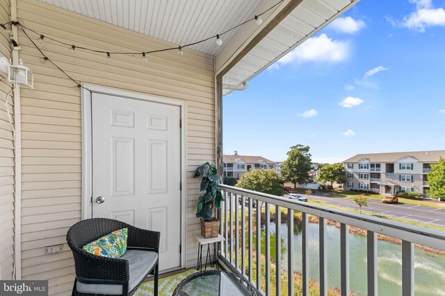 balcony featuring a water view