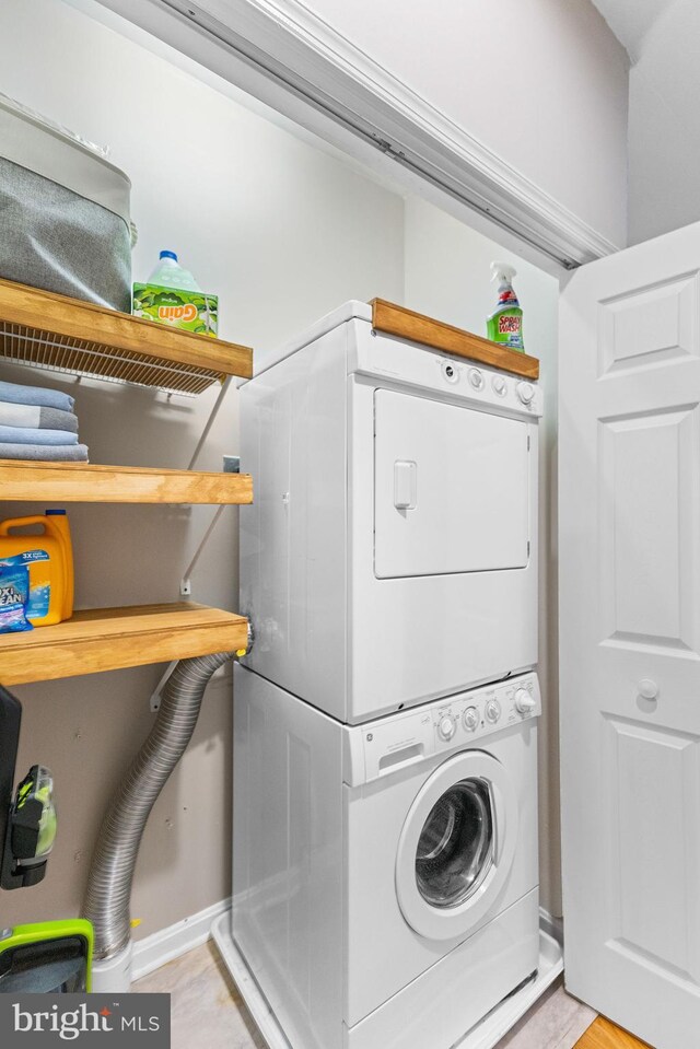 washroom featuring stacked washer and dryer