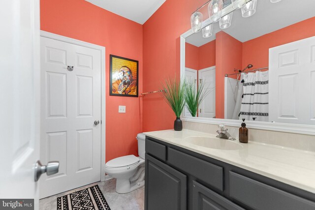 bathroom featuring vanity, toilet, a shower with curtain, and tile patterned floors