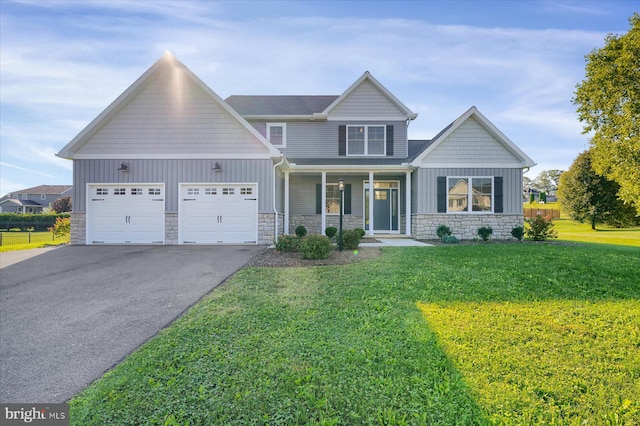 craftsman inspired home featuring covered porch, a front yard, and a garage