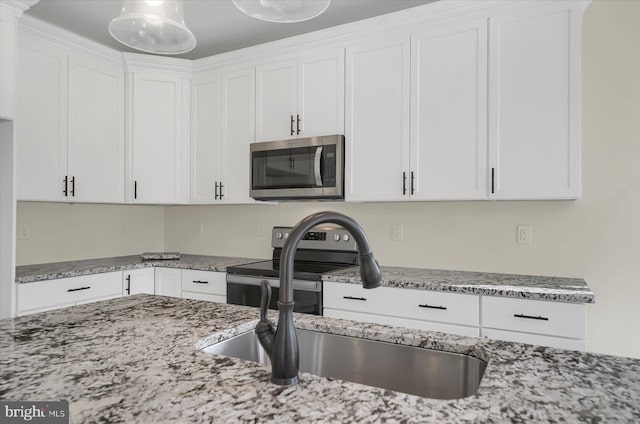 kitchen featuring white cabinetry, sink, appliances with stainless steel finishes, and light stone counters