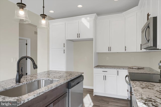 kitchen featuring hanging light fixtures, white cabinetry, sink, and appliances with stainless steel finishes