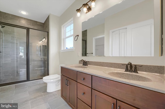 bathroom with toilet, vanity, and walk in shower