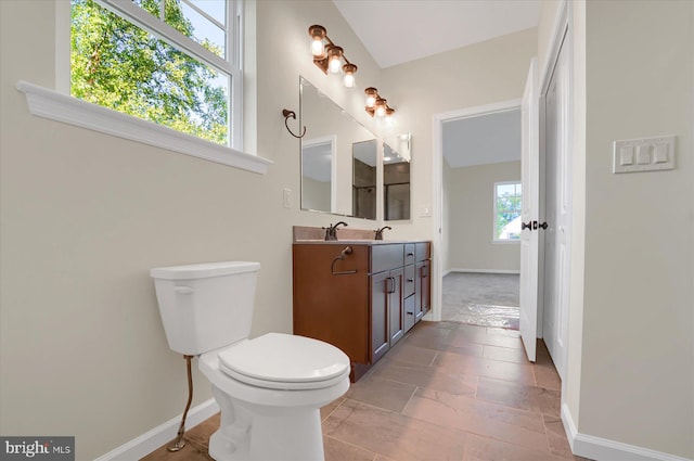 bathroom featuring vanity, toilet, and a healthy amount of sunlight