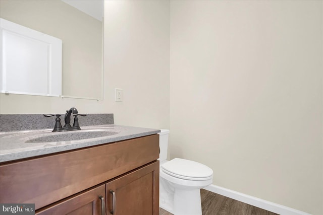83 Landon Dr, Bellefonte, PA 16823 - half bath with vanity, toilet, wood finished floors, and baseboards