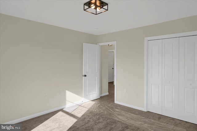 unfurnished bedroom featuring carpet floors and a closet