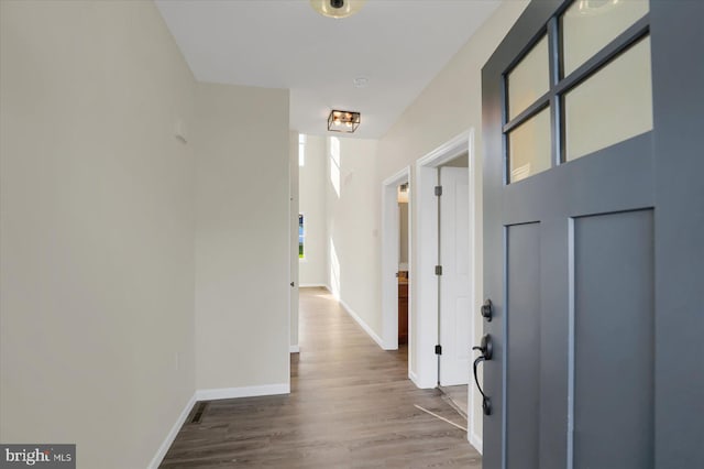 hallway with hardwood / wood-style flooring