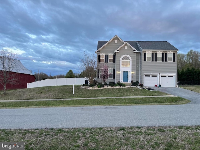 view of front of house featuring a garage and a front lawn