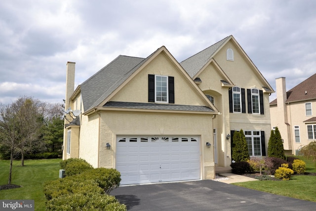 view of front of home featuring a garage and a front yard