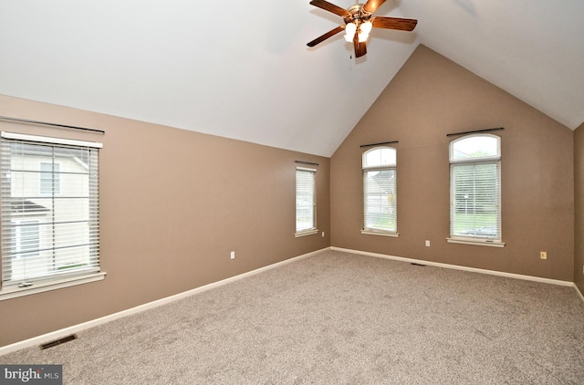 carpeted empty room featuring ceiling fan and vaulted ceiling