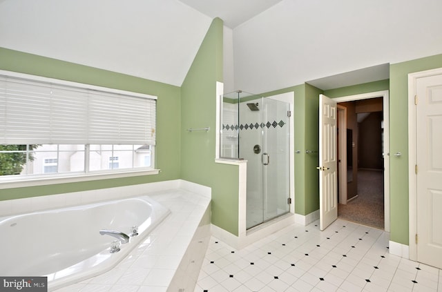 bathroom with tile patterned floors, vaulted ceiling, and shower with separate bathtub