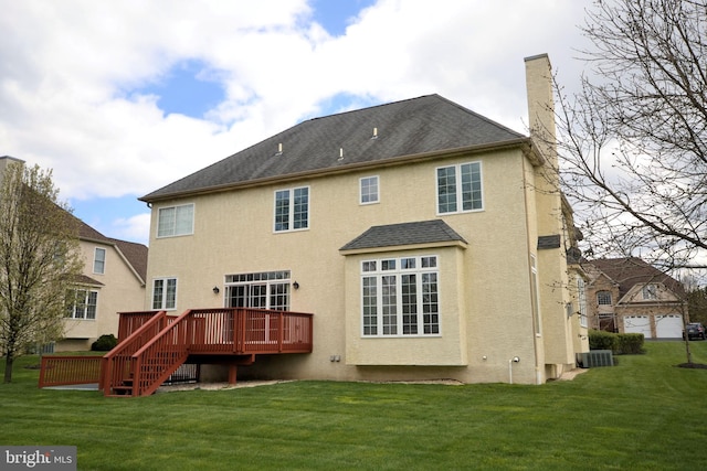 back of house featuring a yard, a wooden deck, and central air condition unit