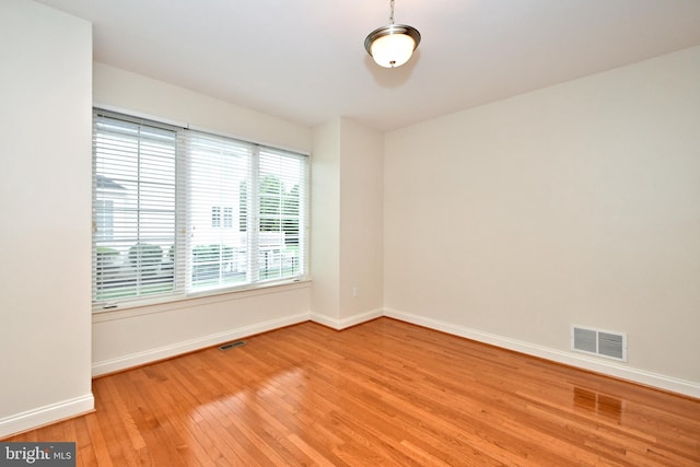 unfurnished room with light wood-type flooring