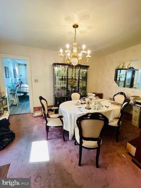 dining space featuring an inviting chandelier and carpet floors