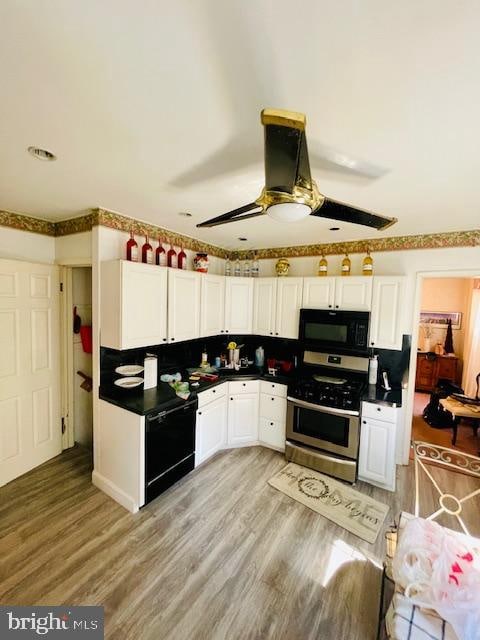 kitchen with white cabinets, black appliances, light hardwood / wood-style flooring, and ceiling fan