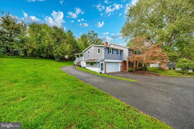 view of front facade featuring a garage and a front lawn