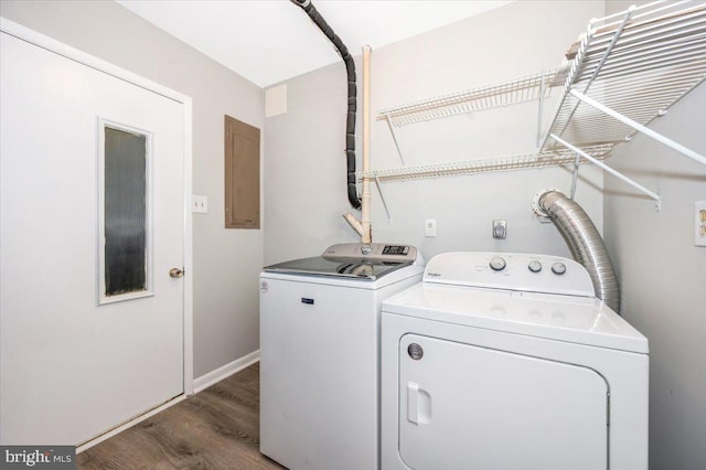 washroom featuring electric panel, dark wood-type flooring, and washing machine and dryer