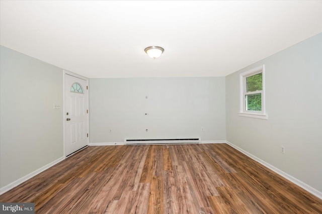 unfurnished room with a baseboard radiator and dark hardwood / wood-style flooring