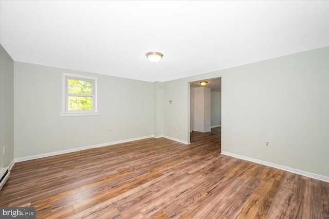 spare room with wood-type flooring