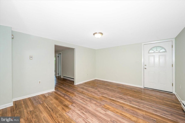 foyer with baseboard heating and hardwood / wood-style flooring