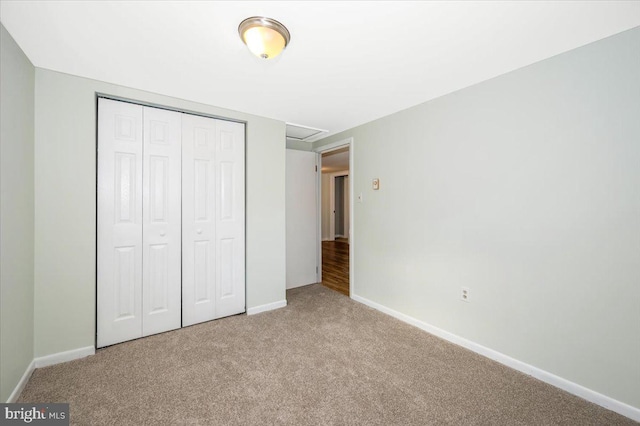 unfurnished bedroom with light carpet and a closet