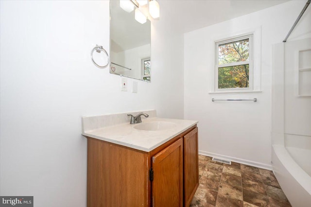 bathroom featuring shower / washtub combination and vanity