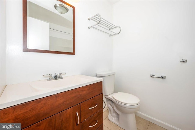 bathroom featuring tile patterned floors, vanity, and toilet