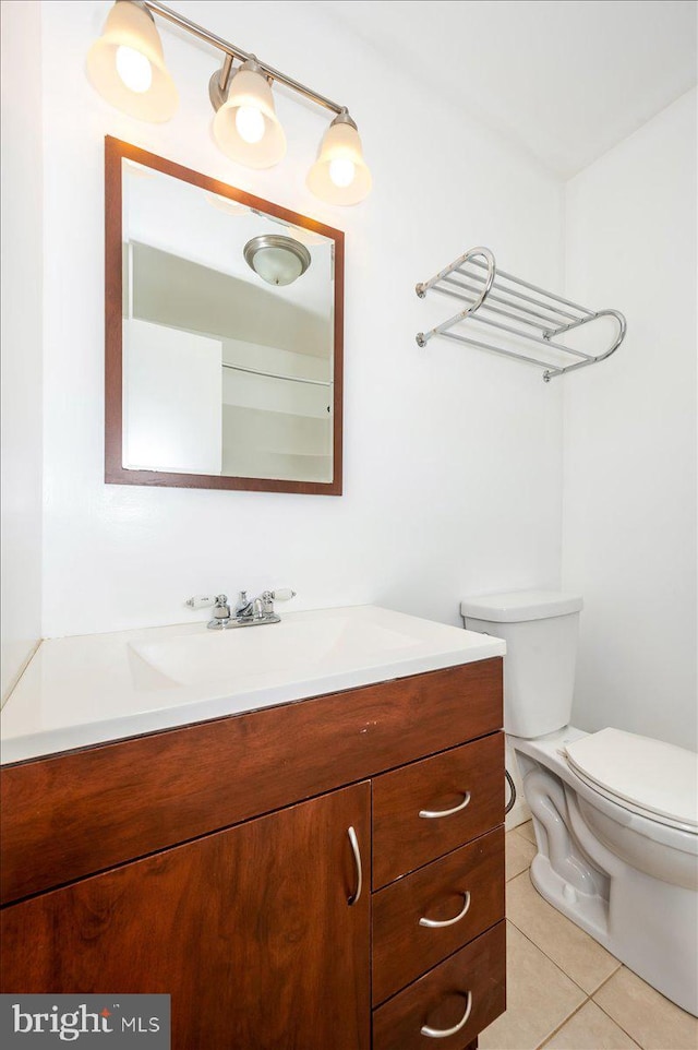 bathroom featuring tile patterned flooring, vanity, and toilet