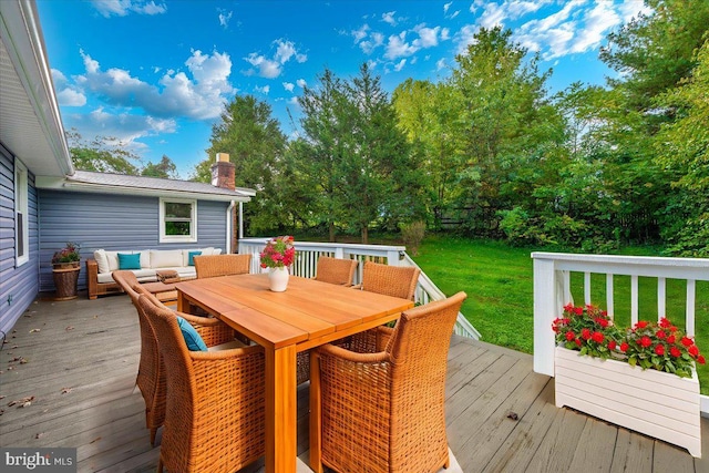 wooden terrace featuring a yard